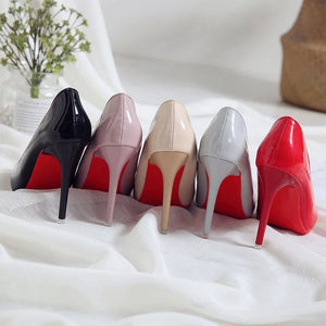 LORVENES Pure Essence heels featuring sleek black leather with pointed toes and stiletto heels, stylish and elegant footwear.
