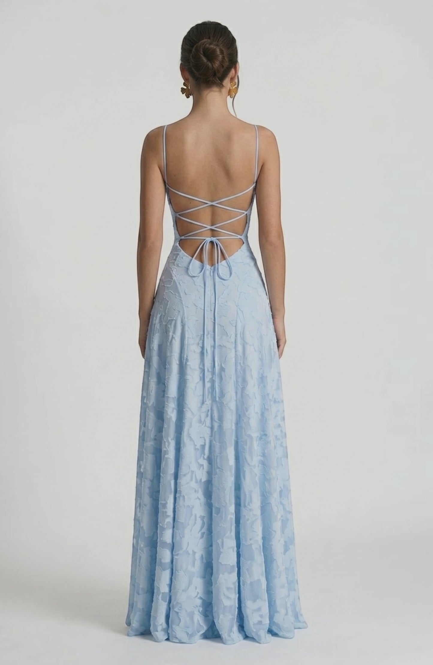 LORVENES sexy flowy bridal dress shown from the back, featuring elegant fabric and a graceful silhouette for wedding attire.