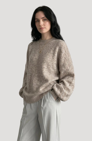 LORVENE cropped rib pullover displayed in a relaxed pose, showcasing the fitted knit and cropped design in a neutral setting.
