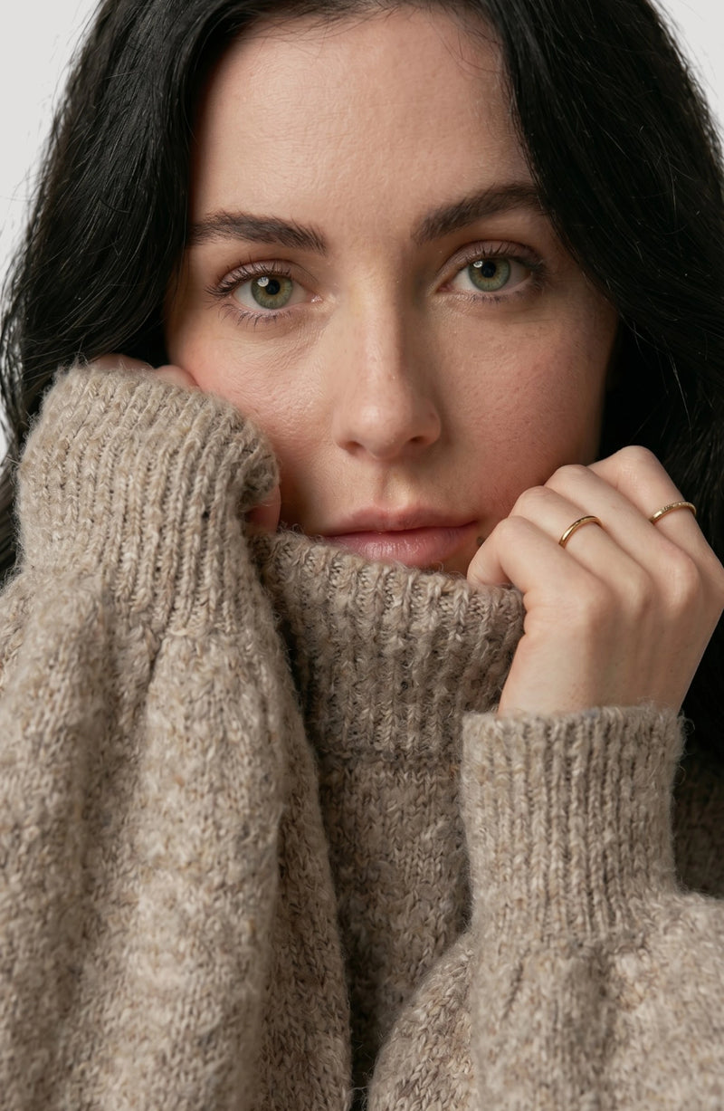 LORVENE cropped rib pullover shown from the bottom right pose, featuring a fitted knit design in a neutral color.