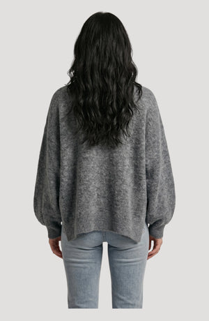 LORVENE cropped rib pullover displayed in a top-right pose, showcasing its fitted style and ribbed texture.