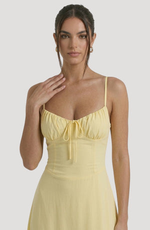 LORVENE Pure Ruffle Maxi dress shown from bottom left, featuring flowy fabric and ruffle details in a full-length style.