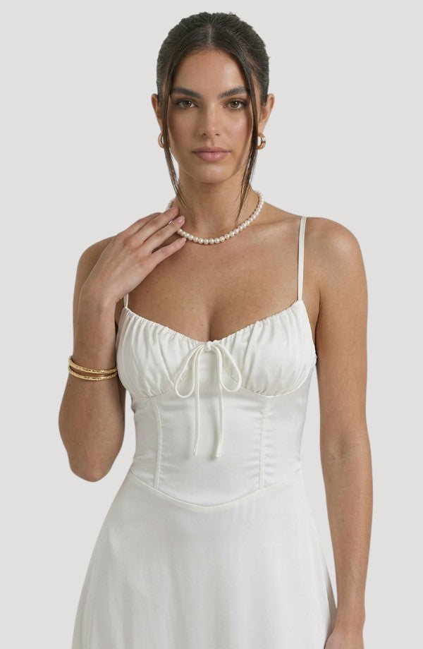 LORVENE Pure Ruffle Maxi dress with flowing fabric and ruffled hem, shown from the bottom left angle.