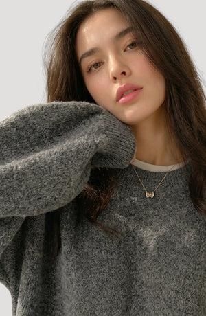 LORVENES oversized sweater in neutral color, featuring a relaxed fit and soft knit fabric, displayed on a hanger.