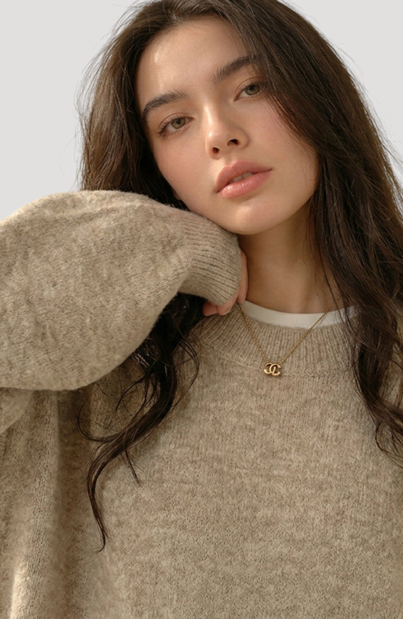 LORVENES everyday oversized sweater in neutral color, shown from the bottom right angle, highlighting its relaxed fit and cozy fabric.