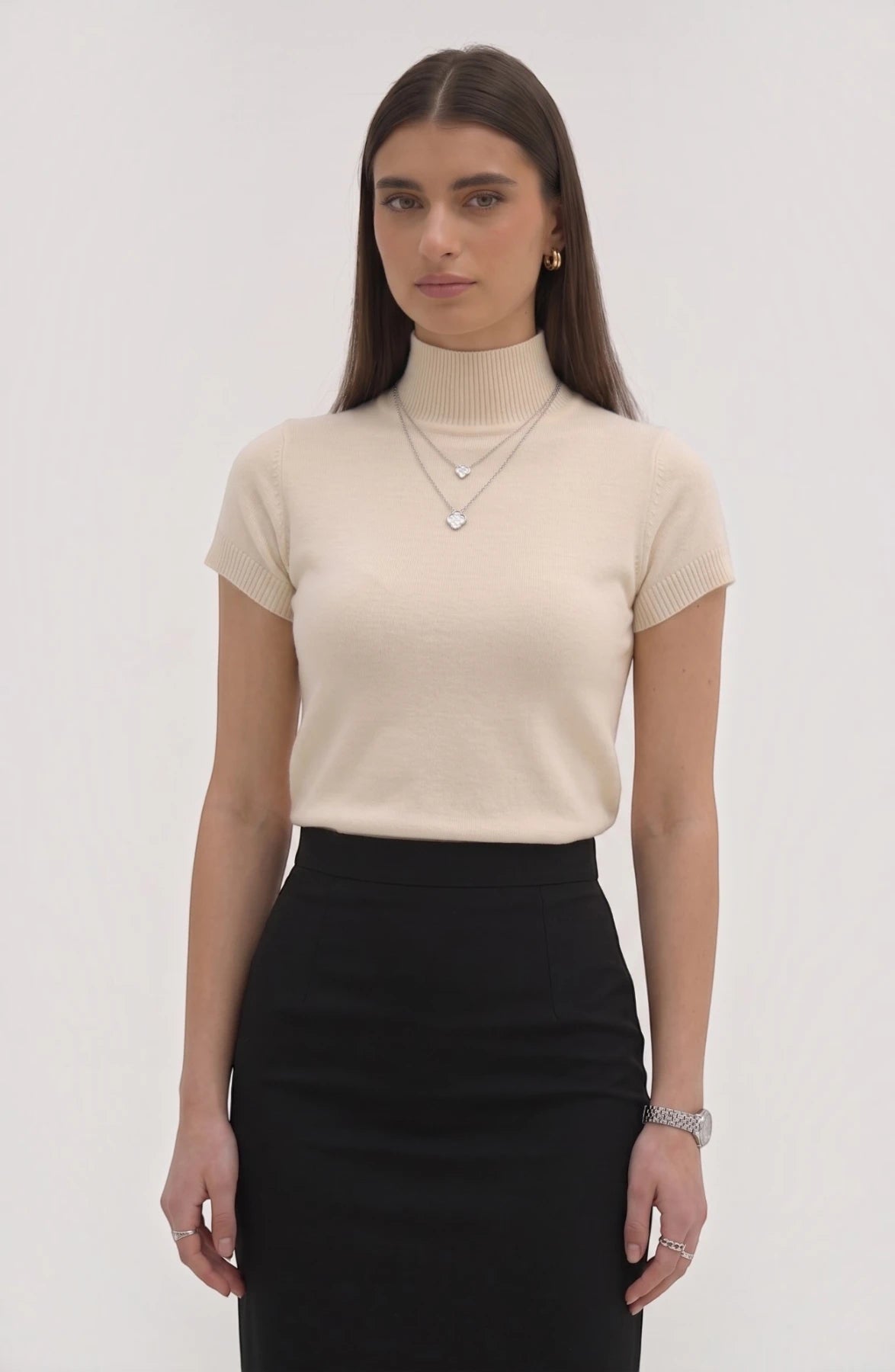 LORVENE pure poly blend high neck top in black, showcasing the close-up fabric texture and high neckline design.