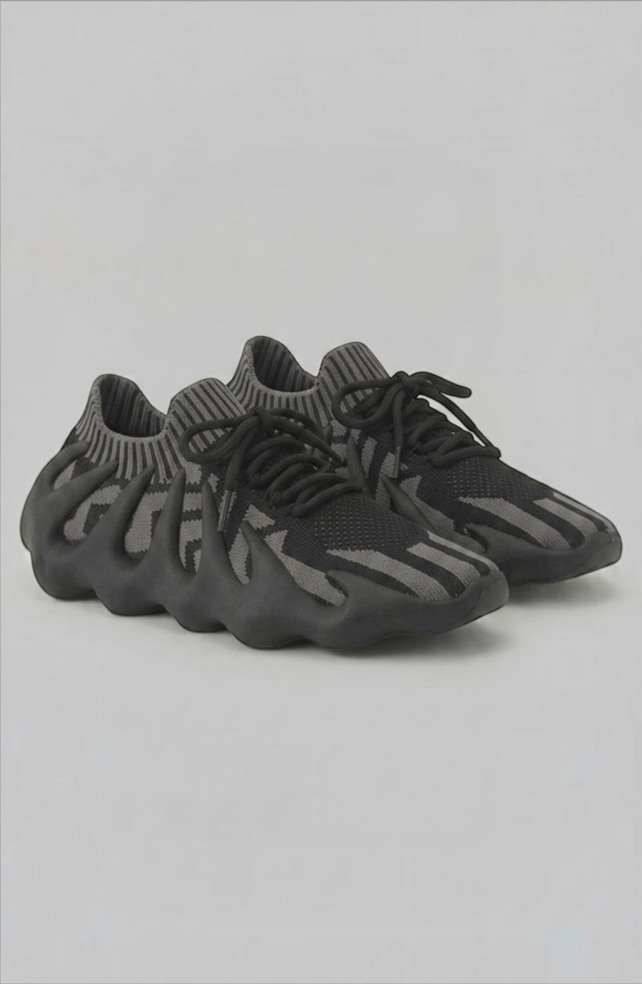 LORVENES Midnight Muse sneakers featuring black and gray color with stylish laces and sleek design.