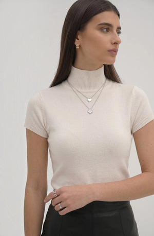 LORVENE Pure Poly Blend High Neck top in neutral color, featuring a close-up of the high neckline and soft fabric texture.