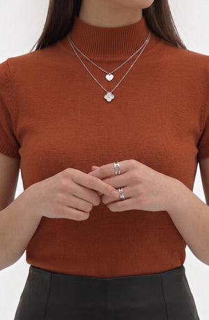 LORVENE Pure Poly Blend High Neck top displayed on a hanger with a close-up of the fabric and high neckline.