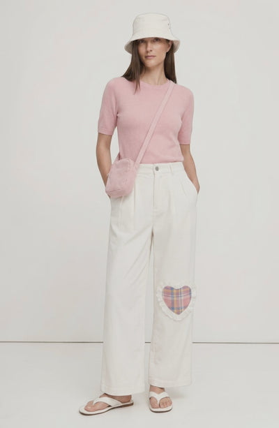 LORVENE Sleek Ease Pants in black, shown on a model from the top left pose, highlighting the smooth fabric and relaxed fit.
