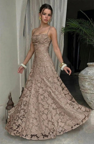 Model wearing a sexy, flowy bridal dress by LORVENES in a soft color, featuring elegant fabric and delicate design details.