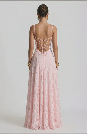 Model wearing a sexy, flowy bridal dress in a soft color by LORVENES, featuring elegant fabric and a graceful silhouette.