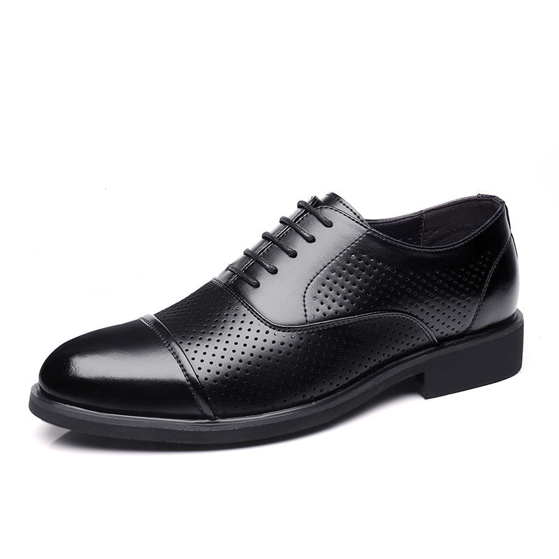 Black leather dress shoe with a close-up of the sole on a white background