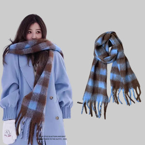 Woman wearing a plaid scarf with AISU TEXTILE OVANCY branding on a snowy background.