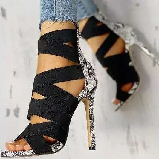 LORVENE Crystal Curve Heels featuring elegant transparent straps and sparkling crystal embellishments on a sleek stiletto sole