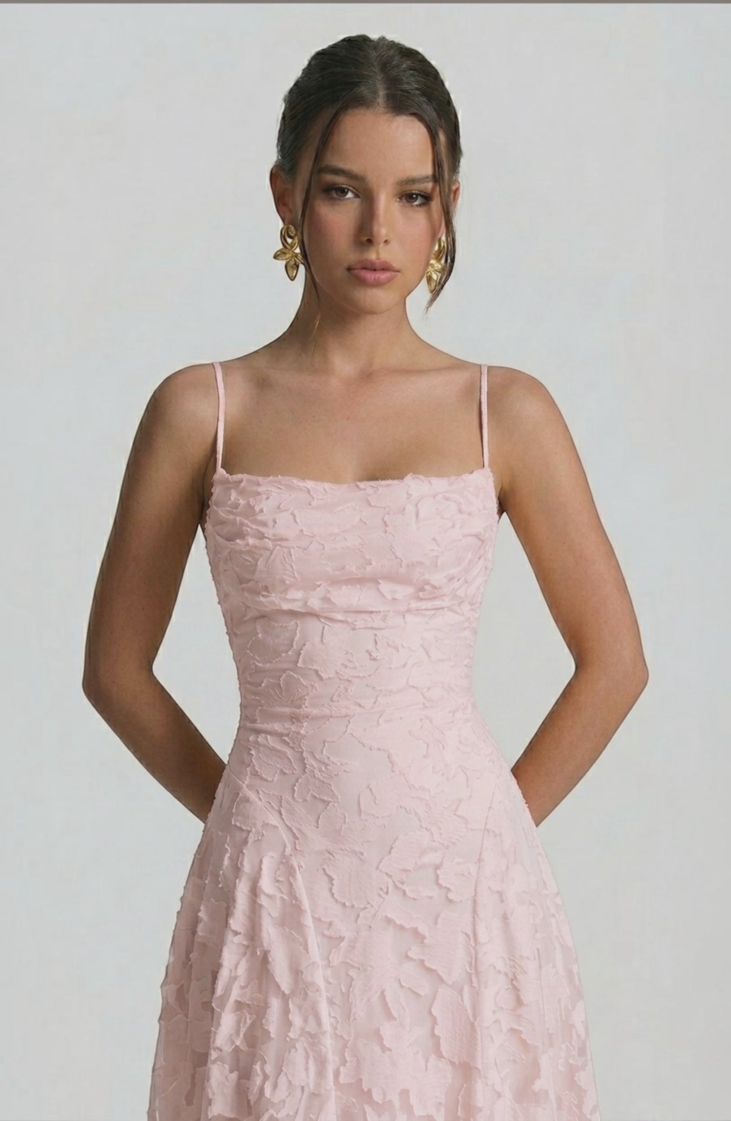 LORVENES sexy flowy bridal dress in soft pastel color with elegant draping and delicate fabric, perfect for a romantic wedding look.