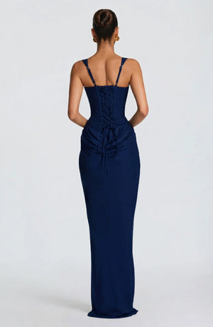 LORVENES halter bodycon maxi dress in vibrant color, fitted silhouette, with plunging neckline and flowing hem, worn by a model.
