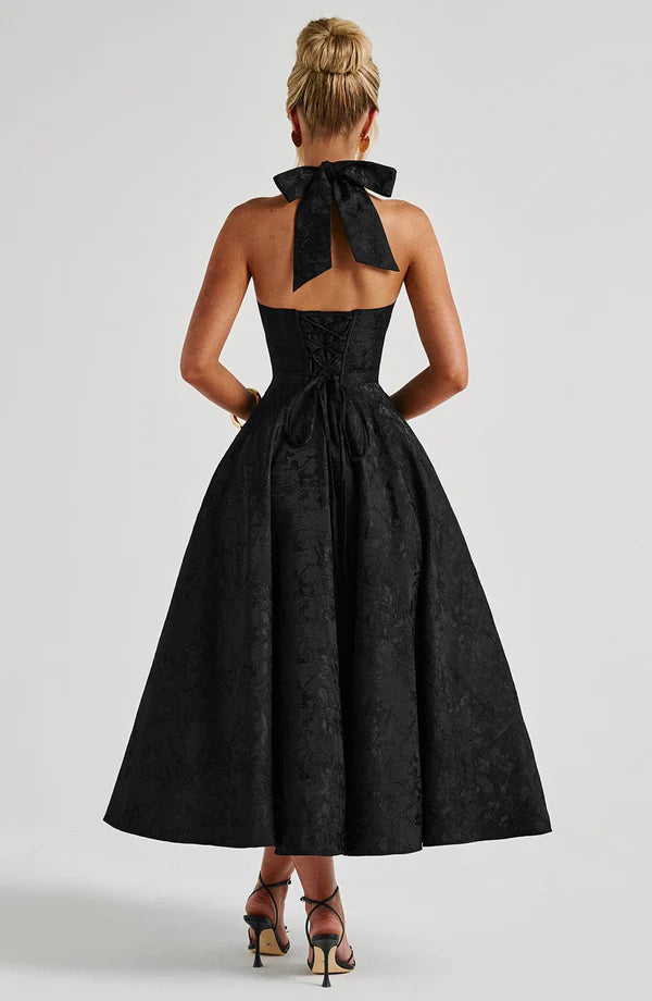 Black modern flow maxi dress by LORVENE featuring a sleek, elegant design and flowing fabric.