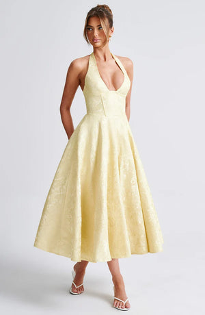 LORVENE Modern Flow Maxi dress in lemon color, featuring a flowing midi design with a fitted bodice and sleeveless style.