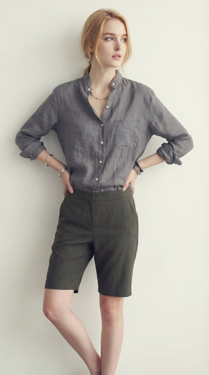 LORVENE classic button-up shirt in crisp white fabric, featuring a collared neckline and long sleeves.