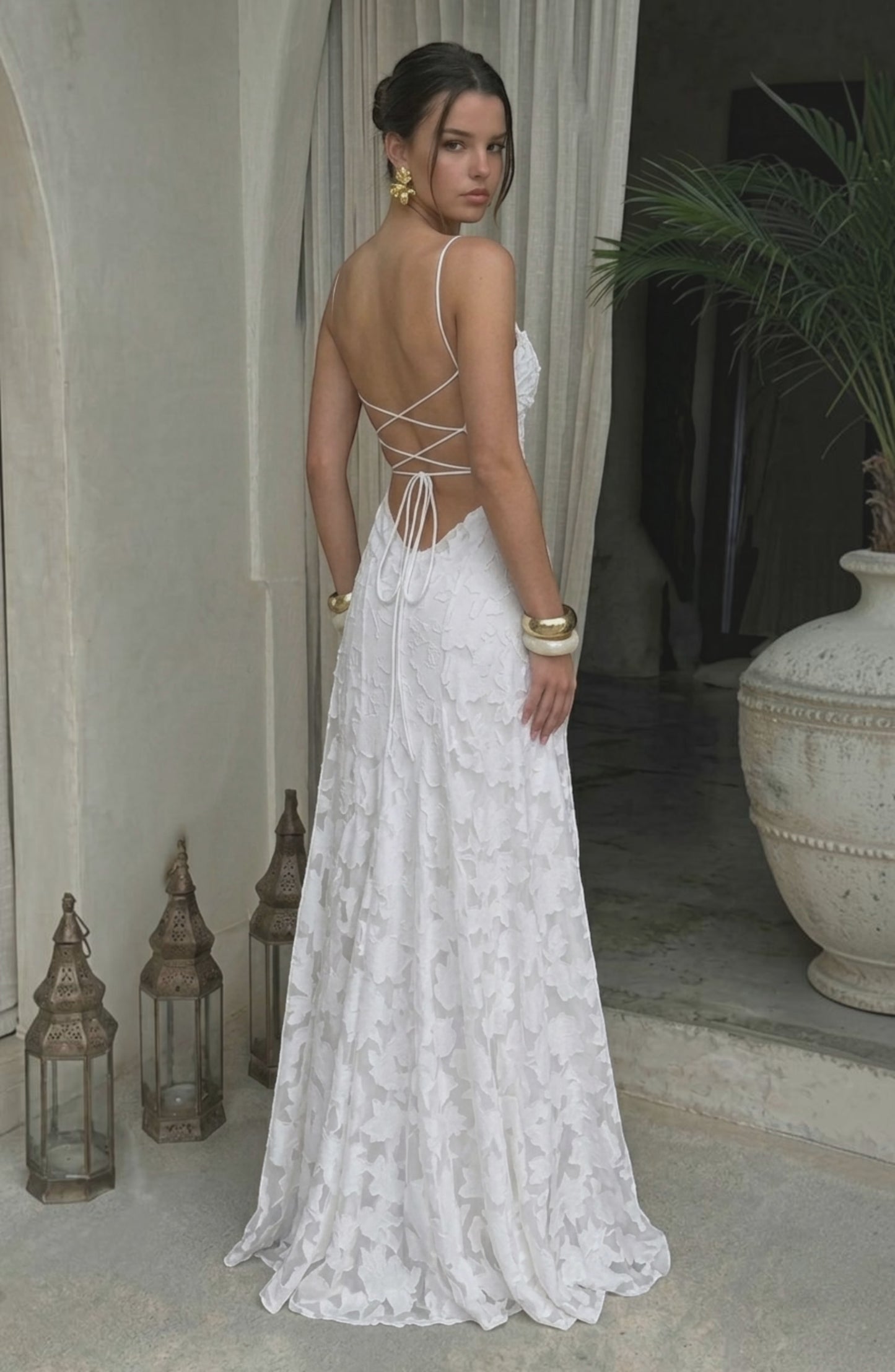 Elegant flowy white bridal dress by LORVENES featuring a soft, flowing fabric and delicate design for a romantic wedding look.