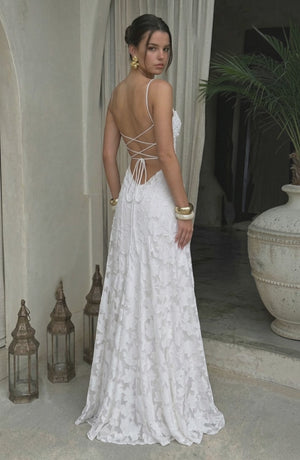 Elegant flowy white bridal dress by LORVENES featuring a soft, flowing fabric and delicate design for a romantic wedding look.