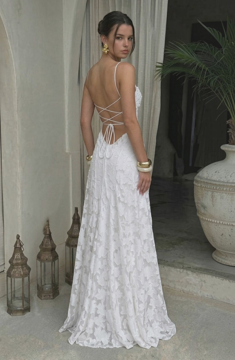 Elegant flowy white bridal dress by LORVENES featuring a soft, flowing fabric and delicate design for a romantic wedding look.