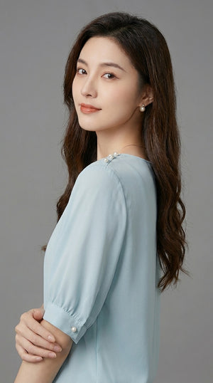 LORVENE chic blouse shirt with long sleeves and button-down front, shown on a hanger in a natural fabric setting.