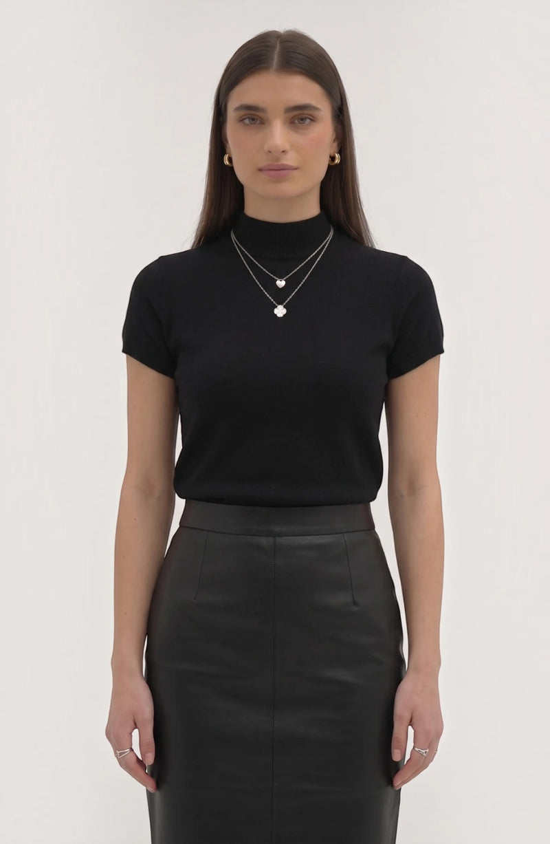 LORVENE Pure Poly Blend High Neck top shown in black with a close-up of the high neckline and smooth fabric texture.