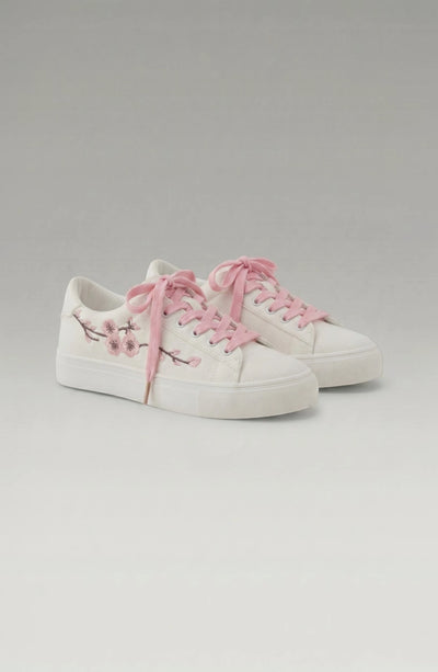 LORVENE Crystal Tone Sneakers featuring clear and sparkling design with white soles and stylish accents.