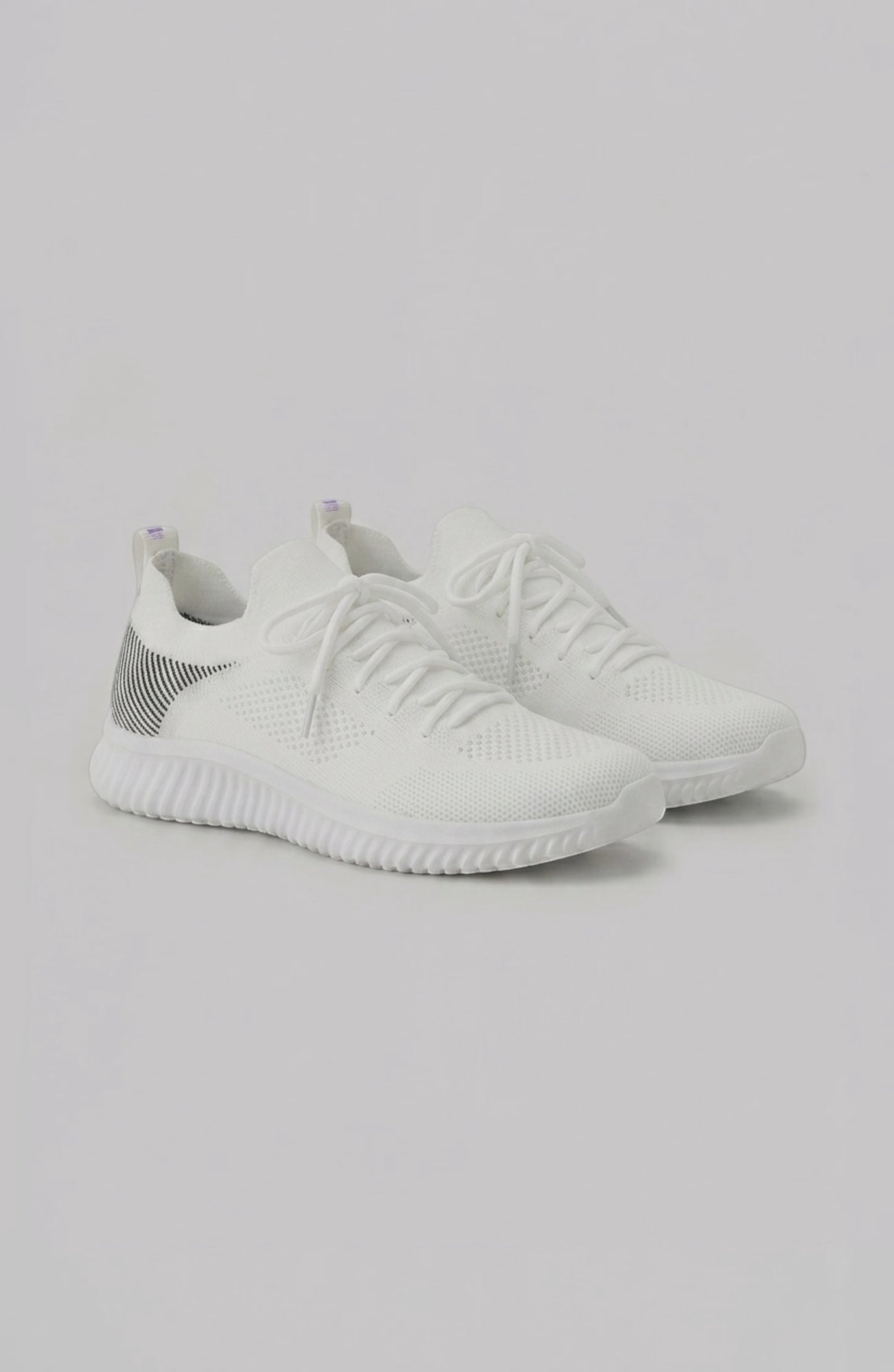 LORVENE Polar Crest sneakers in black and white with textured soles, displayed from the bottom right angle.