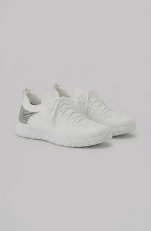 LORVENE Polar Crest sneakers in black and white with textured soles, displayed from the bottom right angle.