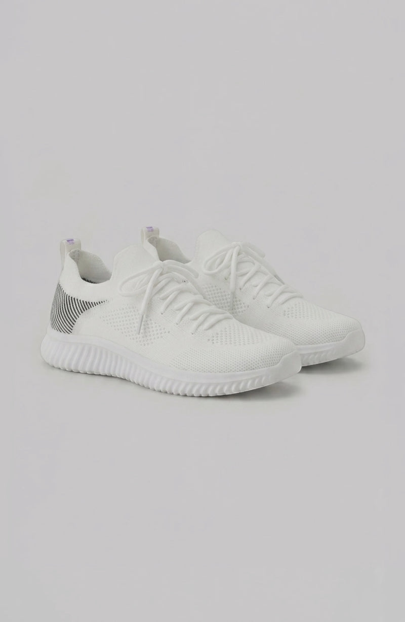LORVENE Polar Crest sneakers in black and white with textured soles, displayed from the bottom right angle.