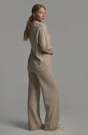 LORVENES knit trouser set featuring a cozy, stylish top and matching trousers worn by a model in a modern indoor setting.