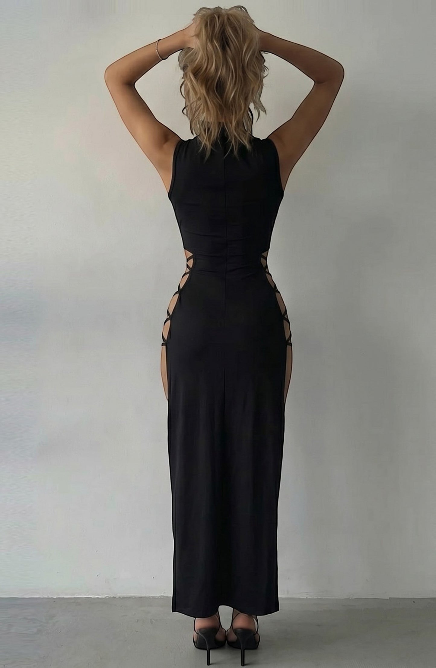 LORVENE black sleeveless maxi dress with cut-out sides and a high neckline, designed for evening wear.