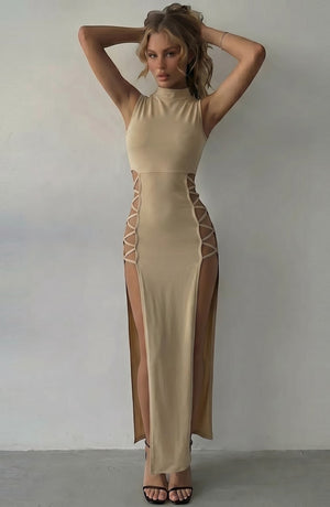 LORVENE beige sleeveless mock neck maxi dress with daring side cutouts and high slits, designed for evening wear.