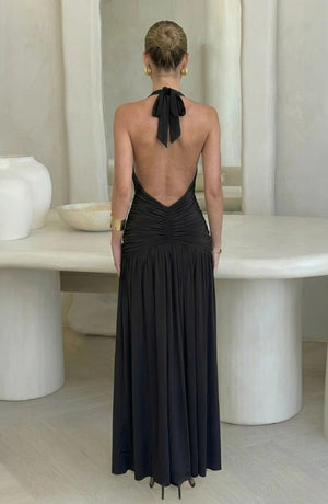 LORVENE black halter neck ruched maxi dress with a low back and tie detail, made from smooth, drapey fabric with a subtle sheen.