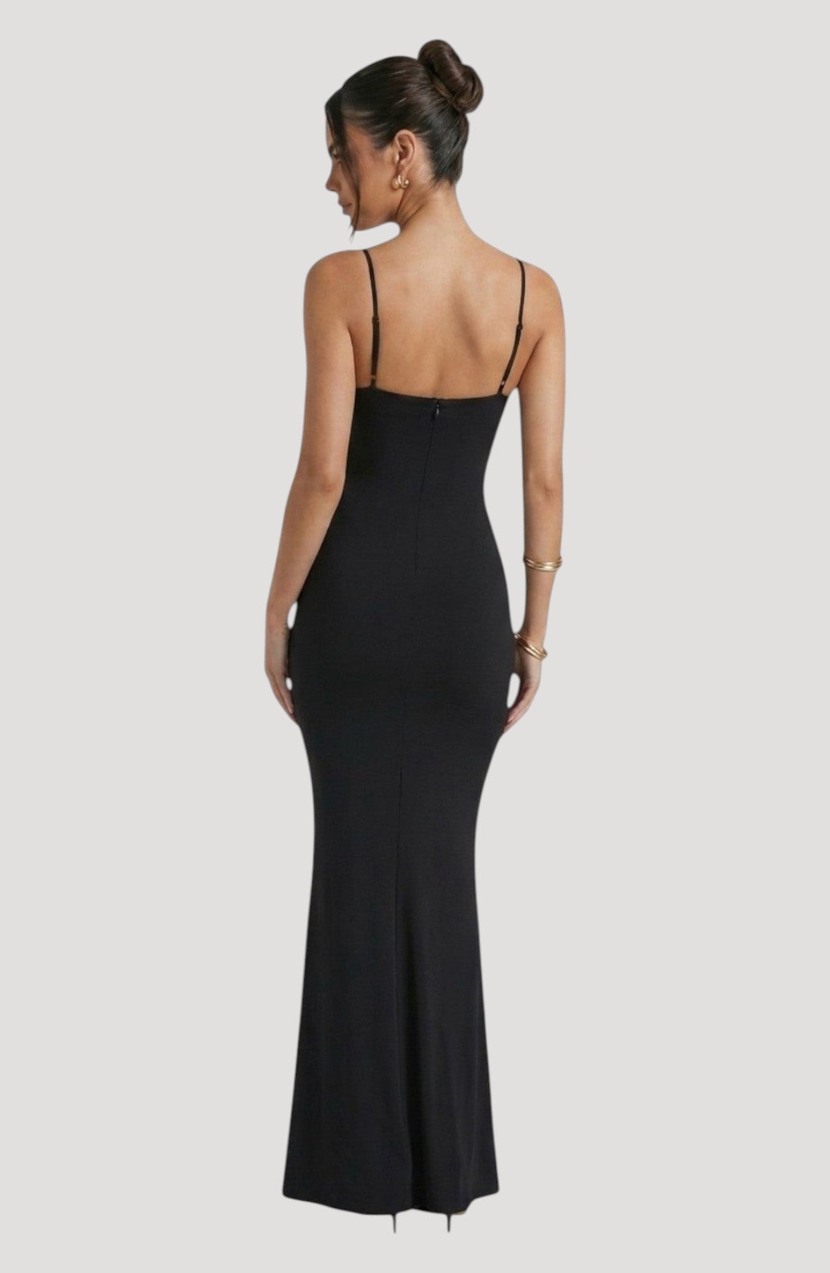 LORVENE black slinky spaghetti strap midi dress with a flattering fit and subtle sheen. Back view.