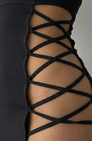 LORVENE black mini dress with strappy side cutouts and a flattering fit, perfect for after-dark events.