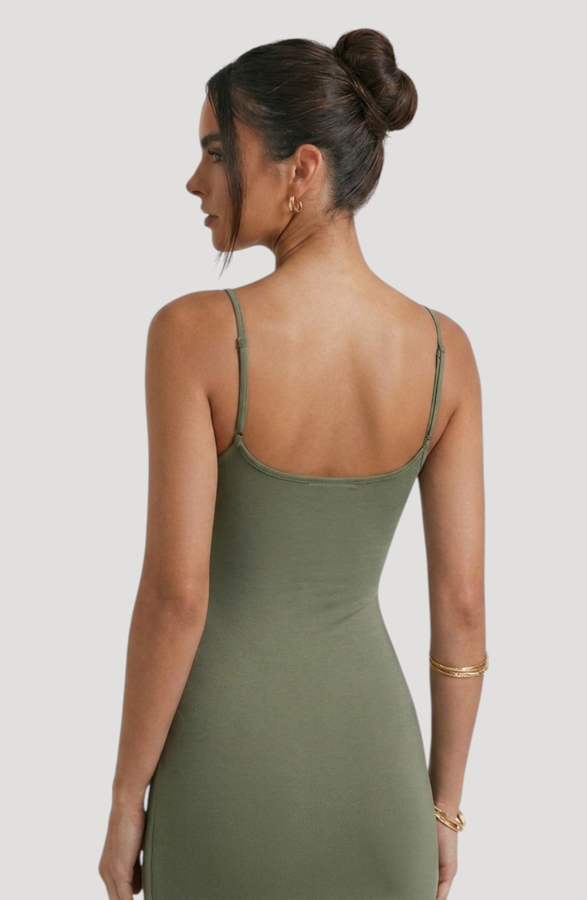 LORVENES olive green spaghetti strap midi dress with a flattering fit and subtle sheen. Model wears gold jewelry.