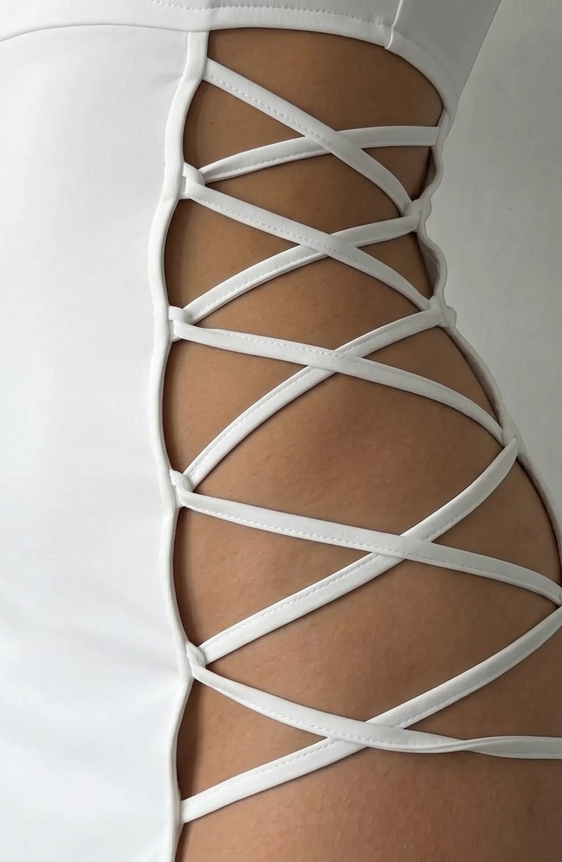 LORVENE white mini dress with crisscross side cutouts and a smooth sheen fabric.