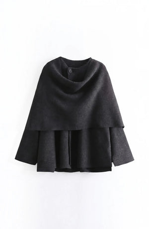 LORVENE cozy blanket shawl draped over a sofa, soft textured fabric in warm neutral tones, perfect for chilly evenings.