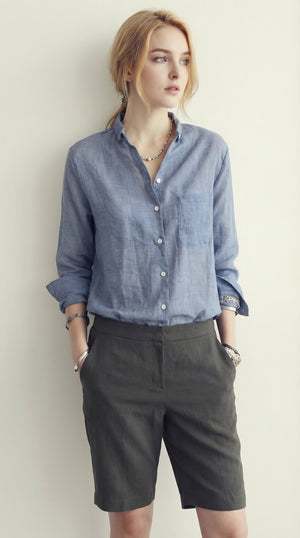 LORVENE classic button-up shirt in white, featuring a collared neckline and long sleeves, displayed on a hanger.