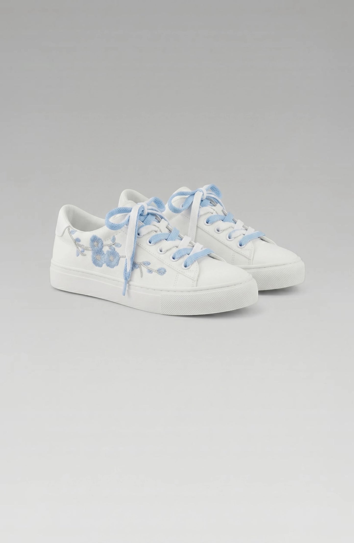 LORVENE Crystal Tone Sneakers featuring clear crystal accents and white athletic soles, stylish and modern footwear.